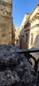 a view of an alley with a table and buildings at Victoria Apt - Historical Centre Lecce in Lecce