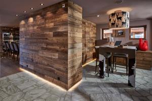 a wooden wall in a restaurant with a table at Chandolin Boutique Hotel in Chandolin