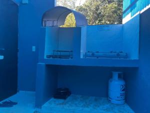 a blue bathroom with a sink and a window at Shawe pension house in San Remigio +9 photos