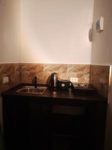 a kitchen with a sink and a counter top at Shawe pension house in San Remigio