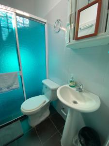 a blue bathroom with a toilet and a sink at Don carmelo in Valledupar