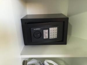 a black microwave on a wall in a bathroom at Wonderful stay in Tenerife Royal Gardens Resort! in Playa de las Americas