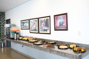 a counter with a bunch of food on it at Colonial Flat Hotel in Itapetininga
