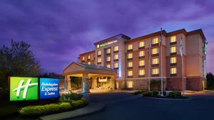 a hotel building with a sign in front of it at Holiday Inn Express & Suites Huntsville by IHG in Huntsville