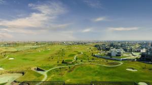 an aerial view of a golf course in a city at Eighteen Islamabad in Islamabad