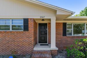 a brick house with a black front door at 2967 Swan Lane in Pensacola