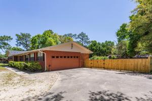 a house with a wooden fence and a driveway at 2967 Swan Lane in Pensacola