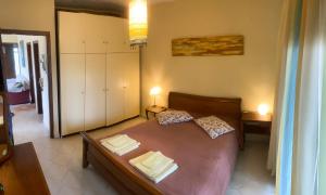 a bedroom with a bed with two pillows on it at Pond and Pines, by nice house by the sea! in Epanomi
