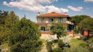 a large yellow house with a red roof at Pond and Pines, by nice house by the sea! in Epanomi