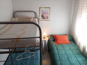 a bedroom with a bunk bed and a small table at Habitacion Privada Triple Toledo in Toledo