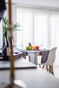 a dining room with a table with fruits and wine glasses at Dunas Club - Hotel & Apartamentos in Corralejo