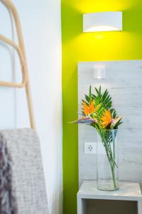 a vase of flowers on a table in a room at Dunas Club - Hotel & Apartamentos in Corralejo