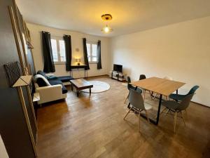 - un salon avec une table et un canapé dans l'établissement Appartements « La Parenthèse », à Wissembourg