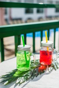 two mason jars filled with colorful liquids sitting on a table at Dunas Club - Hotel & Apartamentos in Corralejo