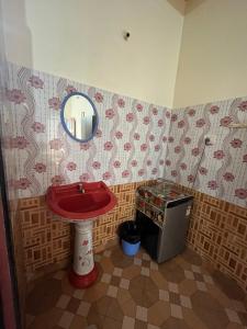 a bathroom with a red sink and a mirror at Casa De Calangute Beach in Calangute