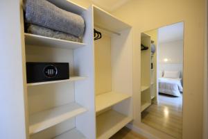 a walk in closet with a mirror and a tv at Colonial Flat Hotel in Itapetininga