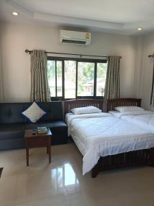 a living room with two beds and a couch at Wasin House One Bedroom - Maenum in Mae Nam