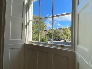 an open door with a window looking out at a street at ※ Stunning, Bath Townhouse, City Centre (AS) ※ in Bath