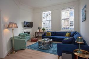 a living room with a blue couch and chairs at ※ Stunning, Bath Townhouse, City Centre (AS) ※ in Bath