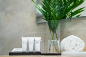 a bathroom with two tubes of sunscreen on a counter at Dunas Club - Hotel & Apartamentos in Corralejo