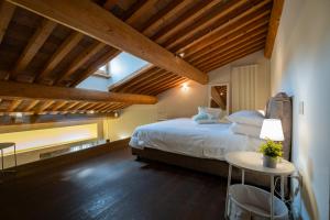 ein Schlafzimmer mit einem großen Bett und einem Tisch in der Unterkunft Appartamento Stella - Verona Centro in Verona