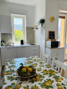 a kitchen with a table with a plate of fruit on it at Casa Vacanze Imma in Sorrento