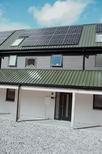 a house with solar panels on top of it at Mews by the tay in Aberfeldy