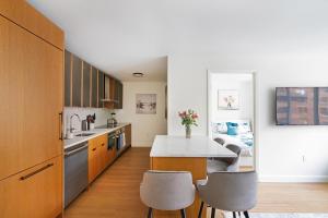 a kitchen with a table and some chairs in it at Luxurious 2 BR Apartment in New York in New York