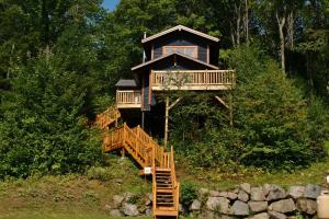 a tree house with a staircase leading up to it at Chalets Alpins - 17 Chemin Alpin in Stoneham