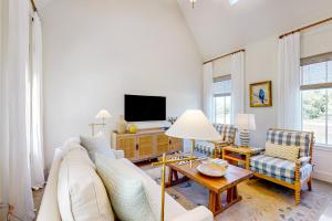 a living room with a couch and a tv at Eco-Chic Lake Somerville Area Farmhouse w/ Porch in Brenham
