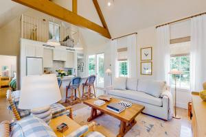 a living room with a couch and a table at Eco-Chic Lake Somerville Area Farmhouse w/ Porch in Brenham
