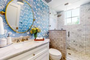 a bathroom with a sink and a mirror at Eco-Chic Lake Somerville Area Farmhouse w/ Porch in Brenham +18 photos