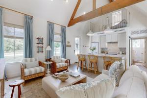 a living room with a couch and a table at Off-Grid & Elegant Farmhouse Near Somerville Lake in Brenham