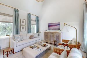 a living room with a couch and a table at Off-Grid & Elegant Farmhouse Near Somerville Lake in Brenham