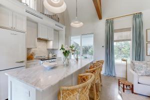 a kitchen with a large island in a room at Off-Grid & Elegant Farmhouse Near Somerville Lake in Brenham +16 photos