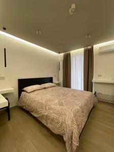 a bedroom with a large bed and a window at Élite Etnea in Catania