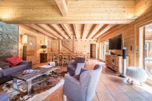 a living room with a couch and a table at Chalet L'aube claire - 5 étoiles in Morzine