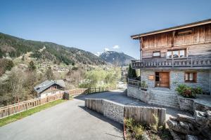 una casa en las montañas al lado de una carretera en Chalet L'aube claire - 5 étoiles en Morzine