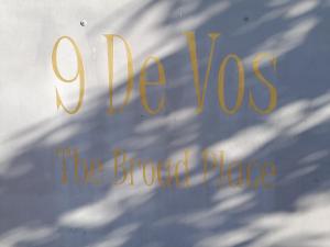 a sign for the brooked place with a shadow of a building at The Broad Place in Worcester