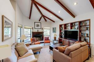 a living room with two couches and a tv at Rockridge in Sedona