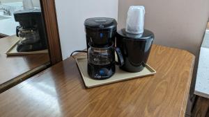 a black coffee maker sitting on a table at Edelweiss Inn New Braunfels in New Braunfels