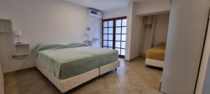 Un dormitorio con una cama grande y una ventana en ParSur alquileres temporales Catamarca en San Fernando del Valle de Catamarca