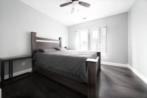 a bedroom with a bed and a ceiling fan at The Maid of the Mist Villa- With Private Yard & Parking, Minutes From Falls & Casino by Niagara Hospitality in Niagara Falls
