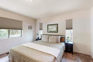 a bedroom with a bed and two windows at Rockridge in Sedona