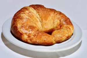 a loaf of bread sitting on a white plate at Dunas Club - Hotel & Apartamentos in Corralejo
