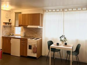 a kitchen with a table and a white stove top oven at Reykjavik city center - Privat studio apartment in Reykjavík