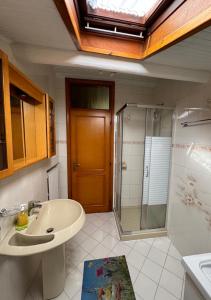 a bathroom with a sink and a shower at Dimora Mariagrazia in Rimini