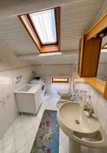 a bathroom with two toilets and a sink and a window at Dimora Mariagrazia in Rimini