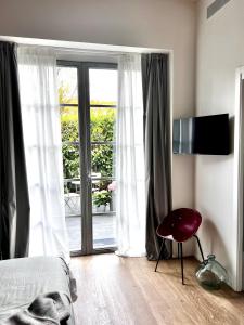a bedroom with a bed and a sliding glass door at Loft G Hospitality in Milan
