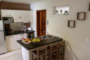a kitchen with a counter with a bowl of fruit on it at Escalonia 2 in Las Terrenas